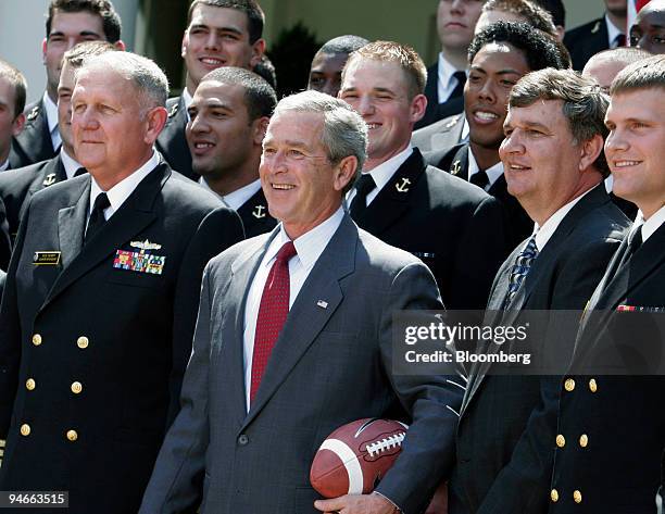 From left to right in front row, Navy Academy Superintendent Vice Admiral Rodney Rempt, President George W. Bush, Coach Paul Johnson, and team...