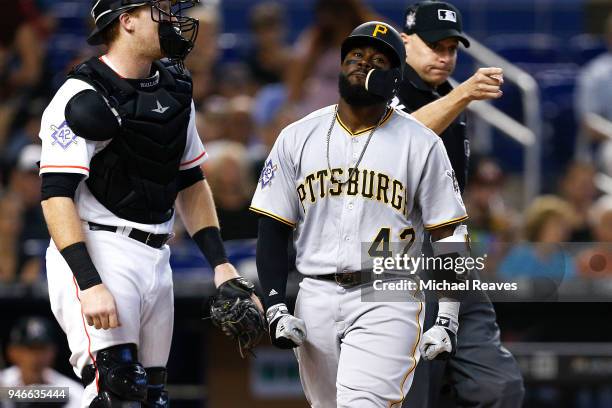 Josh Harrison of the Pittsburgh Pirates reacts after being hit by a pitch in the third inning against the Miami Marlins at Marlins Park on April 15,...