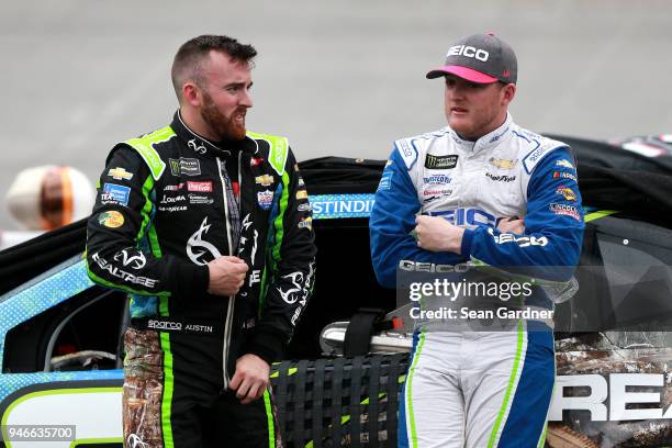 Austin Dillon, driver of the Realtree Chevrolet, and Ty Dillon, driver of the GEICO Chevrolet, stand on pit road during a rain delay for the Monster...