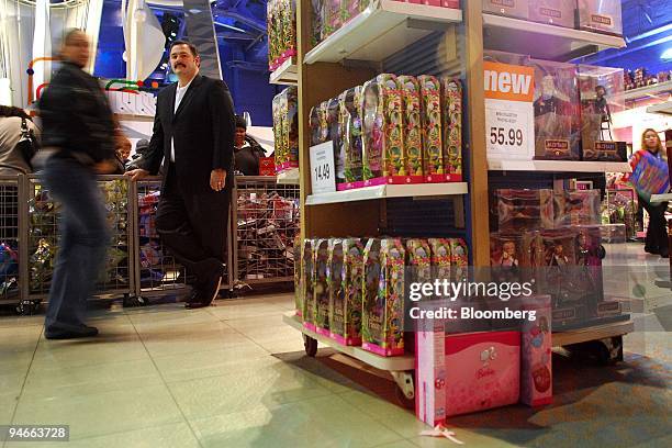 Ron Boire, president of Toys "R" Us Inc.'s North America unit, second from the left, poses as shoppers pass by in the company's Times Square store in...