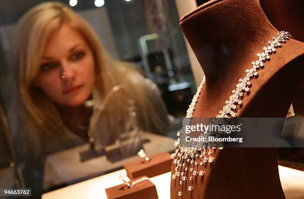 Visitors to the Russian Millionaire fair inspects designer jewelry on display in Moscow, Russia, on Friday, Nov. 23, 2007. The third annual fair...