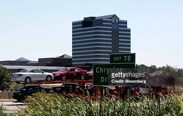 Car hauler with Chrysler Sebring vehicles drives past DaimlerChrysler AG's U.S. Headquarters in Auburn Hills, Michigan, Friday, Aug. 3, 2007....