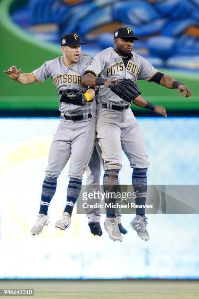 Corey Dickerson, Gregory Polanco and Starling Marte of the Pittsburgh Pirates celebrate after defeating the Miami Marlins 7-3 at Marlins Park on...