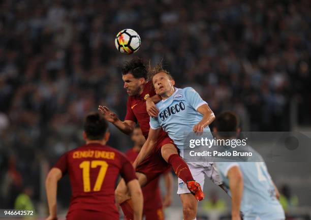 Lucas Leiva of SS Lazio competes for the ball with Kevin Strootman of AS Roma during the serie A match between SS Lazio and AS Roma at Stadio...