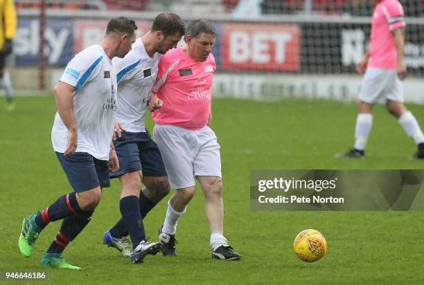 Former Newcastle United, Liverpool and England footballer Peter Beardsley controls the ball watched by reality television personality Daniel Osborne...