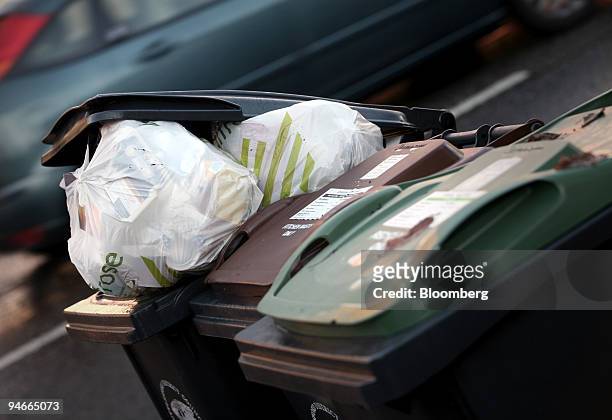 Discarded plastic shopping bags sit in garbage bins in Littlebury, Essex, on Wednesday, Nov. 21, 2007. Britons use 13 billion carrier bags a year,...