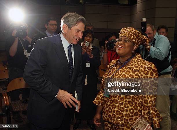 World Bank President Paul Wolfowitz, left, chats with Ngozi Okonjo-Iweala, Finance Minister of Nigeria, before the start of a news conference on...