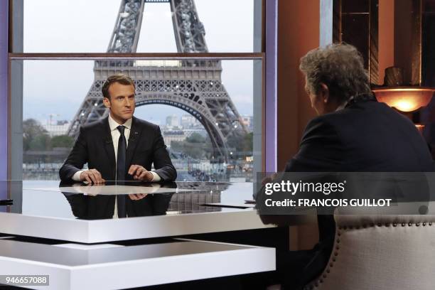 French President Emmanuel Macron poses on the TV set before an interview with RMC-BFM French journalist Jean-Jacques Bourdin and Mediapart...