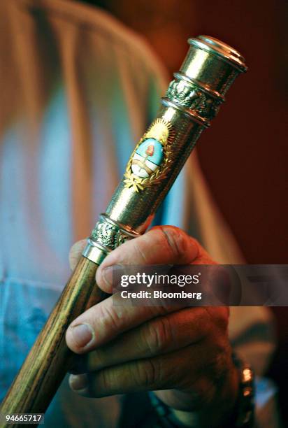 Silversmith Juan Carlos Pallarols holds the presidential stave of office he made for Argentina's president-elect Cristina Kirchner in his workshop in...