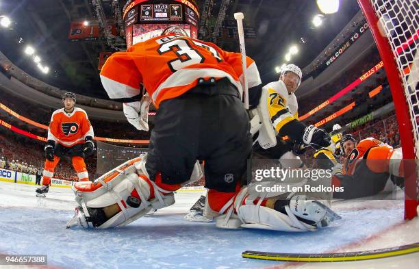 Brian Elliott and Andrew MacDonald of the Philadelphia Flyers surrender a second period power-play goal to Derick Brassard of the Pittsburgh Penguins...