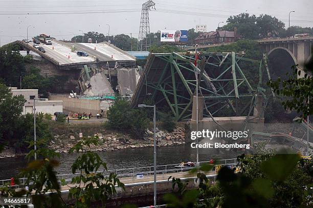 Recovery workers survey the site of a bridge collapsed in Minneapolis, Minnesota, on Wednesday, Aug. 1, 2007. Federal, state and city investigators...