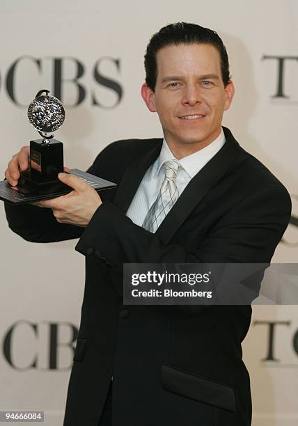 Winner of Best Performance by a Featured Actor in a Musical Christian Hoff poses with his award backstage at the 60th Annual Tony Awards at Radio...