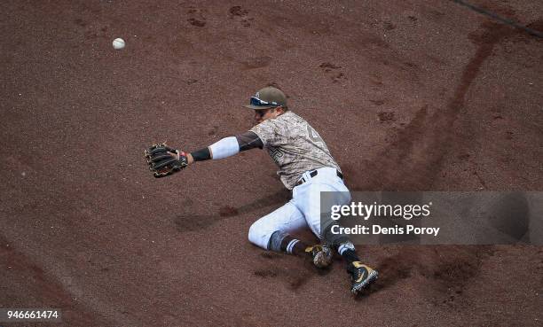 Christian Villanueva of the San Diego Padres can't make a sliding catch on the foul ball hit by Brandon Belt of the San Francisco Giants during the...