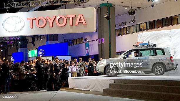 Members of the media and the automotive industry watch as Bob Carter, vice president and General manager of Toyota, sits in the driver's seat of the...