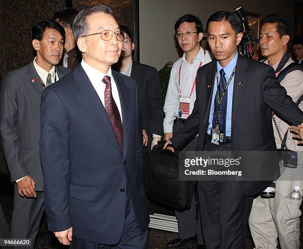 Wen Jiabao, China's premier, is escorted out of the China-Japan bilateral meeting, where he met with Yasuo Fukuda, Japan's prime minister, on the...