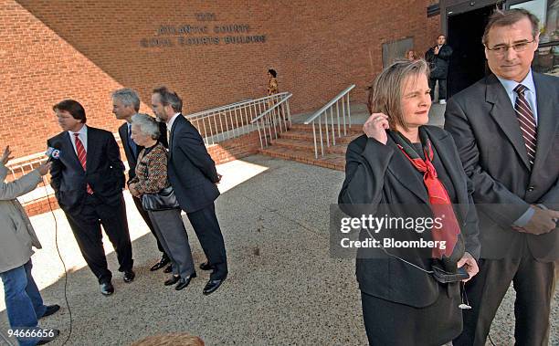 Irma McDarby, rear, wife of plaintiff John McDarby, stands with attorneys Mark Lanier, far left, Robert Gordon, center and Jerry Kristal, as they...