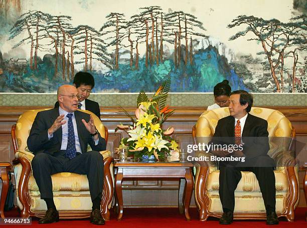 Henry Paulson, secretary of the U.S. Treasury, speaks with Ma Kai, minister of the National Development and Reform Commission, at a state guest house...
