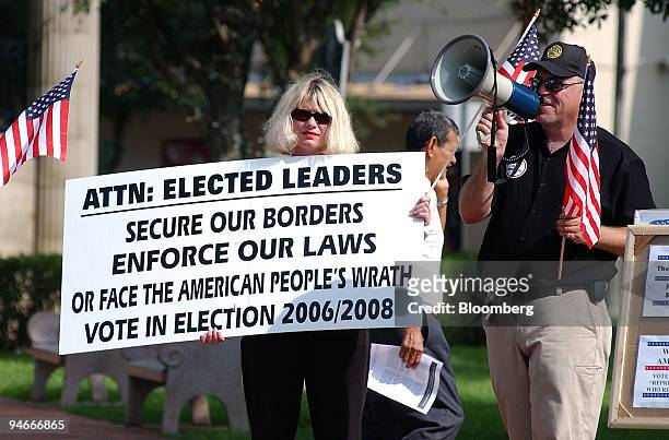 Marcia Mead and Curtis Collier protest outside a House of Representatives subcommittee field hearing titled ?Border Vulnerabilities and International...