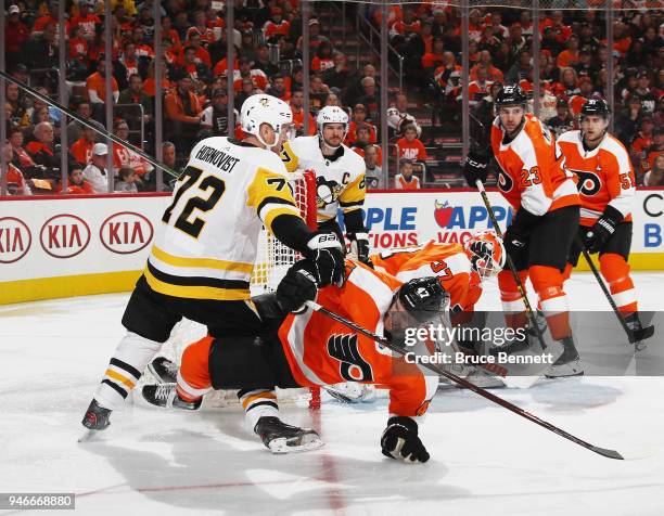 Andrew MacDonald of the Philadelphia Flyers is checked by Patric Hornqvist of the Pittsburgh Penguins during the third period in Game Three of the...