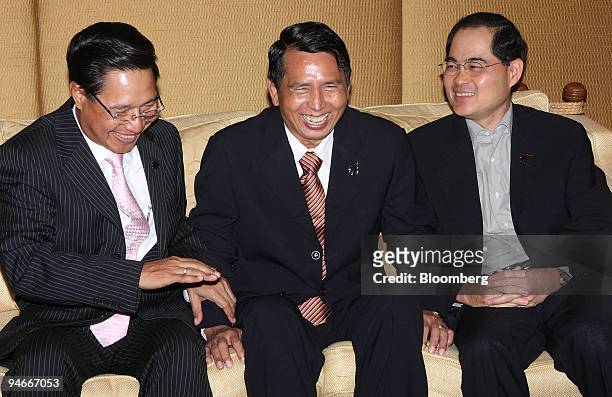 Soe Tha, Myanmar's minister of national planning and economic development, center, shares a laugh with Nam Viyaketh, Laos's minister of industry and...