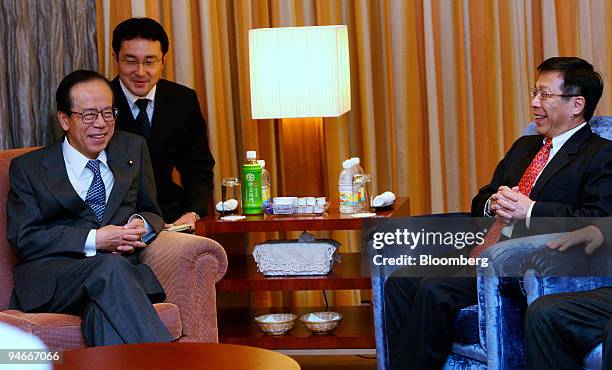 Japanese Prime Minister Yasuo Fukuda, left, chats with Singapore's Minister for National Development Mah Bow Tan, who welcomed him at the airport in...