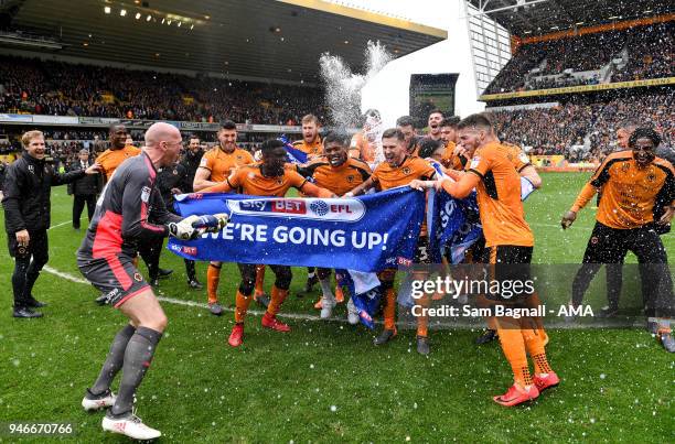 John Ruddy of Wolverhampton Wanderers spays players of Wolverhampton Wanderers with champagne as they celebrate promotion to the Premier League...