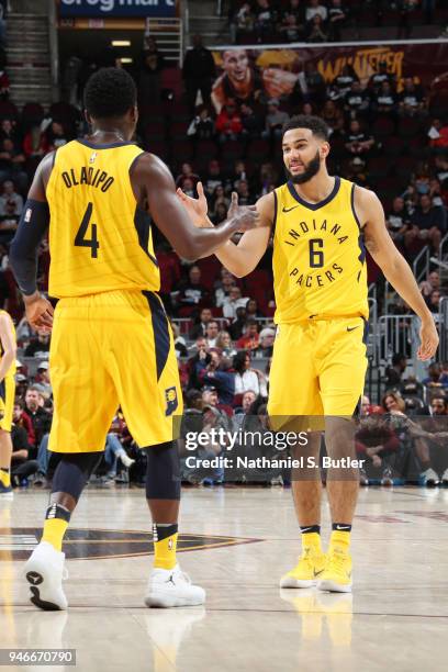 Victor Oladipo and Cory Joseph of the Indiana Pacers exchange high fives against the Cleveland Cavaliers in Game One of Round One of the 2018 NBA...