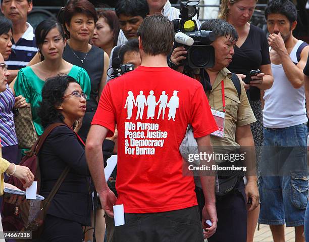 Student protester from the University of Singapore speaks to the media and pedestrians during a demonstration against the military junta of Myanmar,...