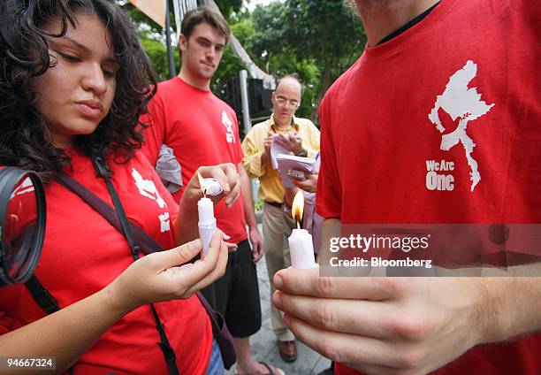 Demonstrators light candles to protest against Myanmar's military junta, near the venue of the 13th Summit of the Association of Southeast Asian...