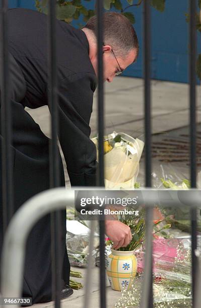 Nicholas Wheeler, the Rector of the Parish of Old St. Pancras places flowers for a visitor to King's Cross station in remembrance of the victims of...