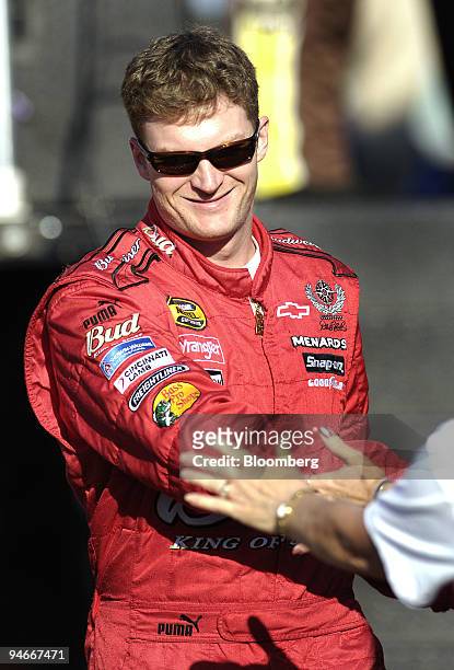 Dale Earnhardt, Jr. Shakes hands with fans prior to the start of the Ford 400 NASCAR race at the Homestead-Miami Speedway in Homestead, Florida, U.S....