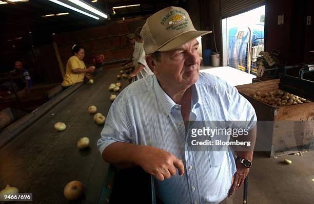Vidalia onion grower R.T. Stanley stands next to one of his processors in Vidalia, Georgia, Thursday, July 6, 2006. Stanley hired 250 laborers, many...