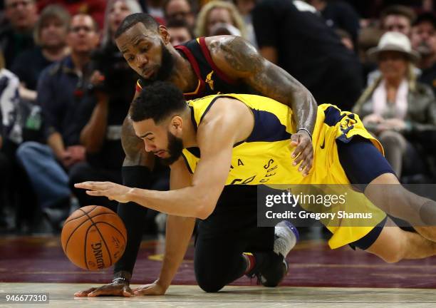 Cory Joseph of the Indiana Pacers dives for the ball in front of LeBron James of the Cleveland Cavaliers during the second half Game One of the...