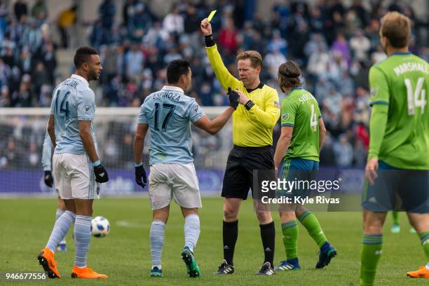 Roger Espinoza of Sporting Kansas City argues with the referee after receiving a yellow card against the Seattle Sounders during the second half on...