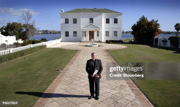 Real estate agent Willie Porteous poses in front of a property currently on the market for $16 million AUS in the Perth, Australia suburb of...