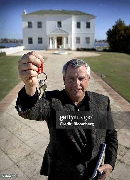 Real estate agent Willie Porteous holds the keys to a property currently on the market for $16million AUS in the suburb of Dalkieth, in Perth,...