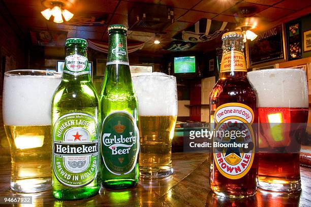 Carlsberg, Heineken, and Newcastle beers are arranged on the bar for an illustration at Paddy McGuire's Pub in New York, New York, U.S., on Thursday,...