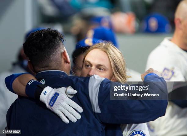 Taylor Motter of the Seattle Mariners greets Felix Hernandez in the dugout after hitting a home run off of Sean Manaea of the Oakland Athletics in...