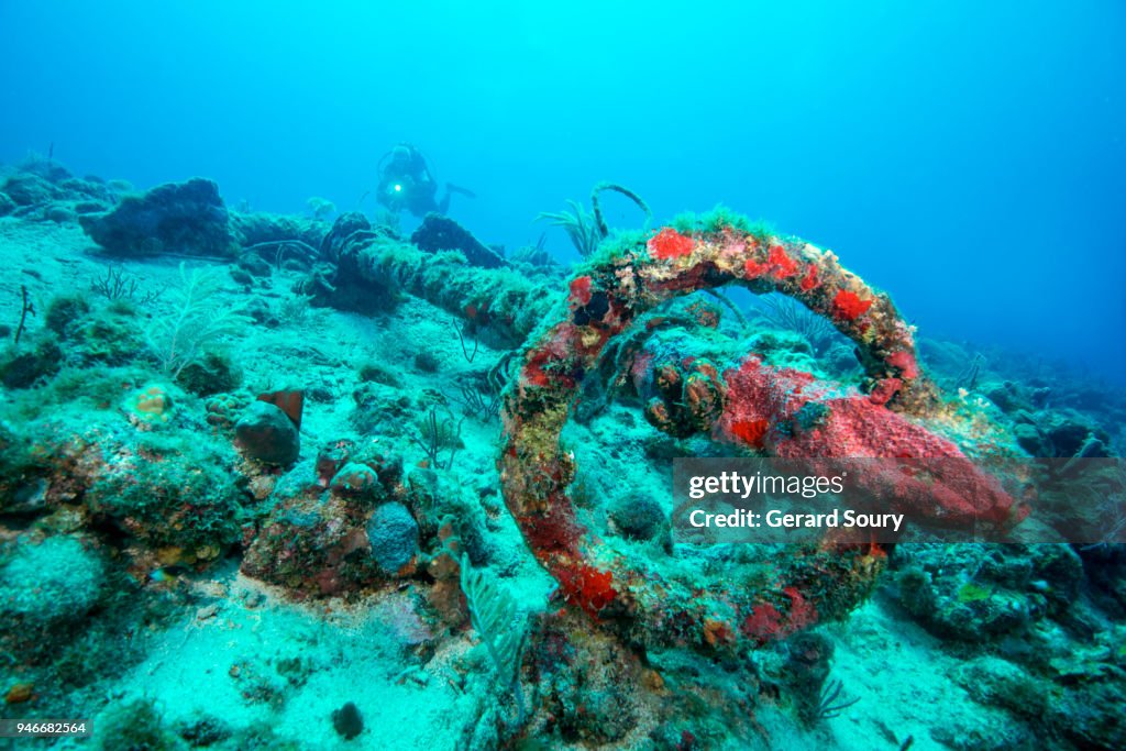 OLD FRENCH ANCHOR ON THE SEA FLOOR WITH A DIVER