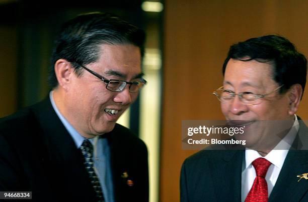 Secretary general Ong Keng Yong, right, is greeted by Philippine foreign affairs secretary Alberto Romulo as he arrives at the meeting of South East...