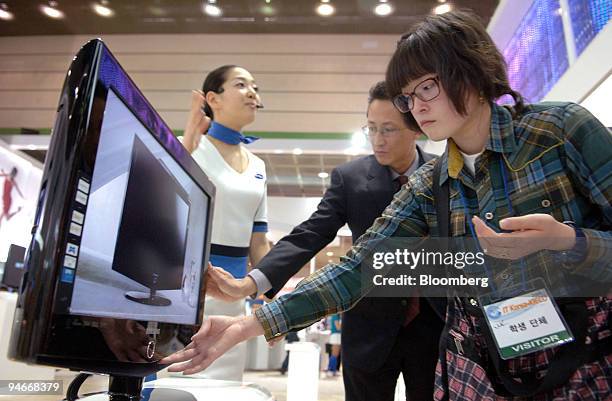 Visitors look at a Samsung Electronics LCD TV at the IT-Korea-KIECO 2006 exhibition in Seoul, South Korea, Thursday, April 13, 2006. Samsung...