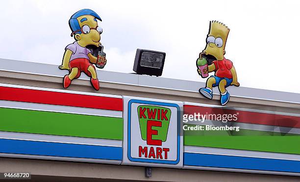 Milhouse Van Houten and Bart Simpson props sit atop a Simpsons-styled "Kwik-E-Mart" 7-Eleven store in Chicago, Illinois, Friday, July 27, 2007. Until...