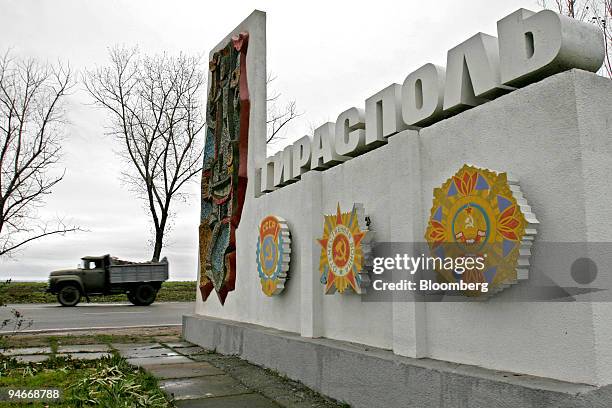 Military truck passes a sign written in Russian announcing the city limits of Tiraspol, the capital of the self-proclaimed Transnistria republic on...