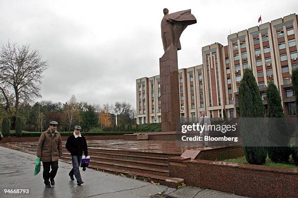 People walk by the "Supreme Soviet" building, or Government headquarters, in Tiraspol, the capital of the self-proclaimed Transnistria republic on...