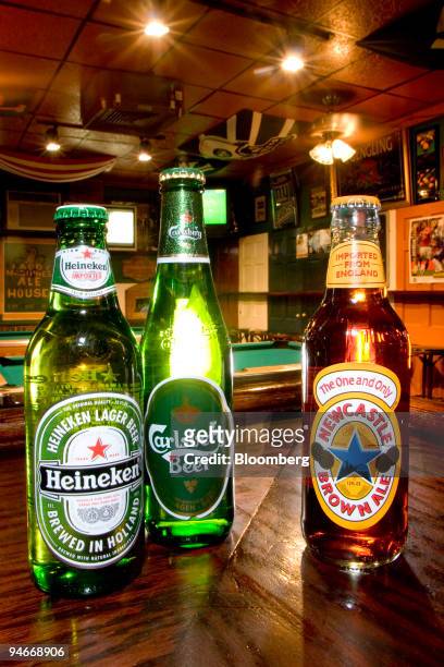 Carlsberg, Heineken, and Newcastle beers are arranged on the bar for an illustration at Paddy McGuire's Pub in New York, New York, U.S., on Thursday,...