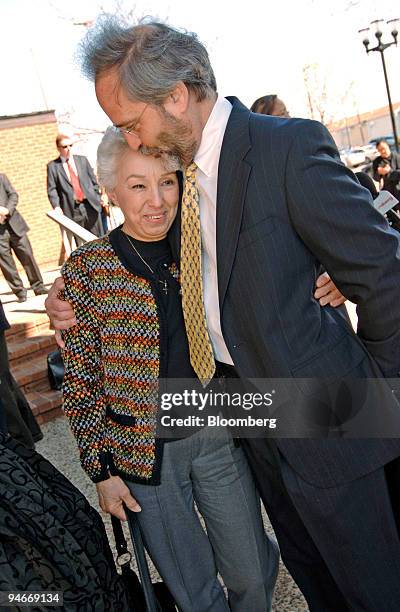 Irma McDarby, wife of plaintiff John McDarby, is hugged by attorney Jerry Kristal outside the Atlantic County Civil Courts Building in Atlantic City,...