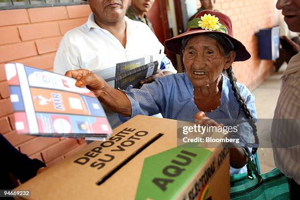 An elderly Quechua farmer casts her ballot in Bolivia's autonomy referendum and elections for the nation's upcoming constituent assembly, in the...