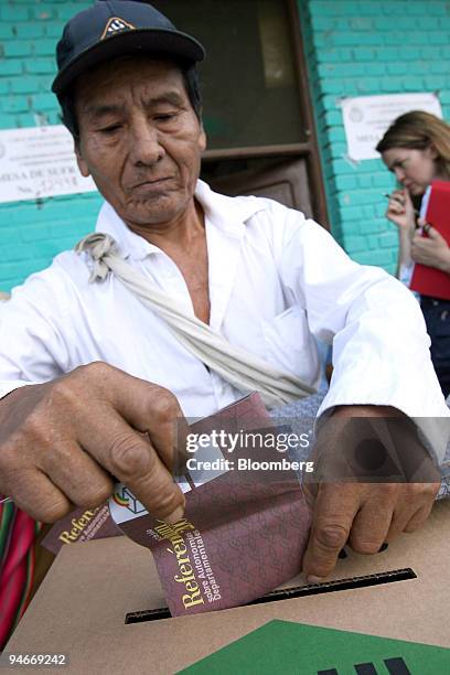 An elderly Quechua farmer casts his ballot in Bolivia's autonomy referendum and elections for the nation's upcoming constituent assembly, in the...