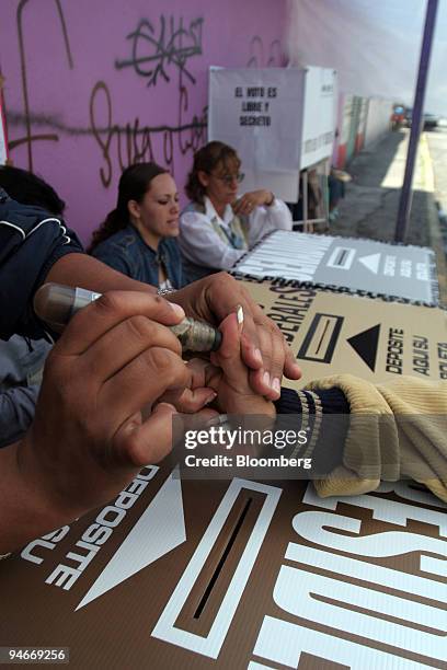 Thumb is marked after a citizen votes in the Mexican elections for president and congress, in the Chimalhuacan county, State of Mexico, July 2, 2006....