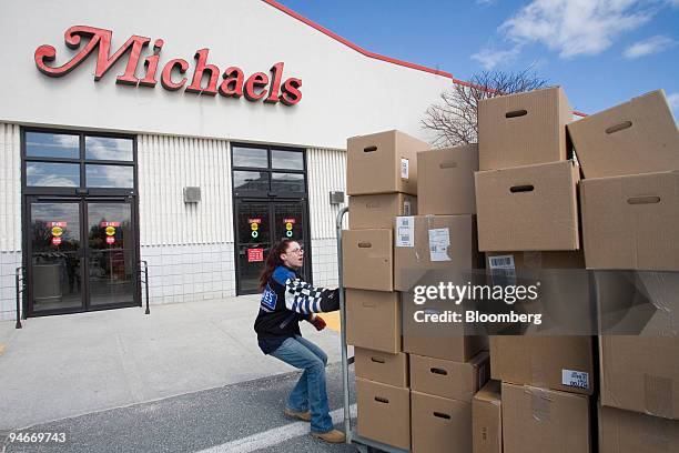 Katie Jones moves a delivery of boxes into a Michaels store in Natick, Massachusetts, Monday, March 20, 2006. Michaels Stores Inc., the biggest U.S....